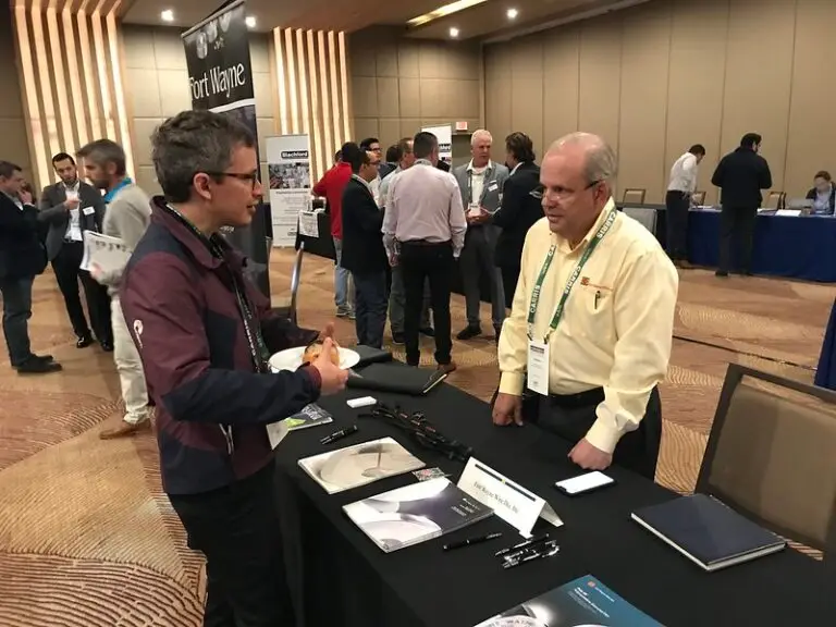 Tino Corral, of Fort Wayne Wire Die, talks dies with an attendee.